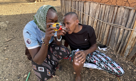 Photo of two people with a film camera